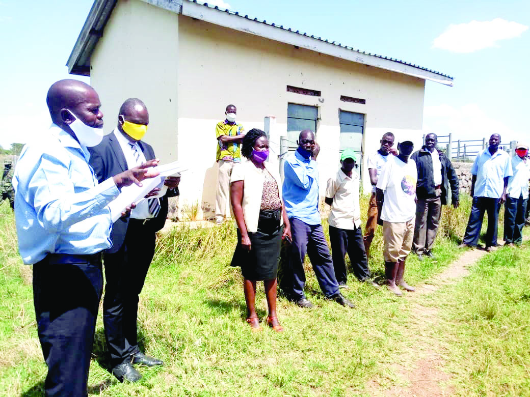 Charles Oule, the Kapelebyong district Engineer explaining to the locals about the Obalanga market construction project 