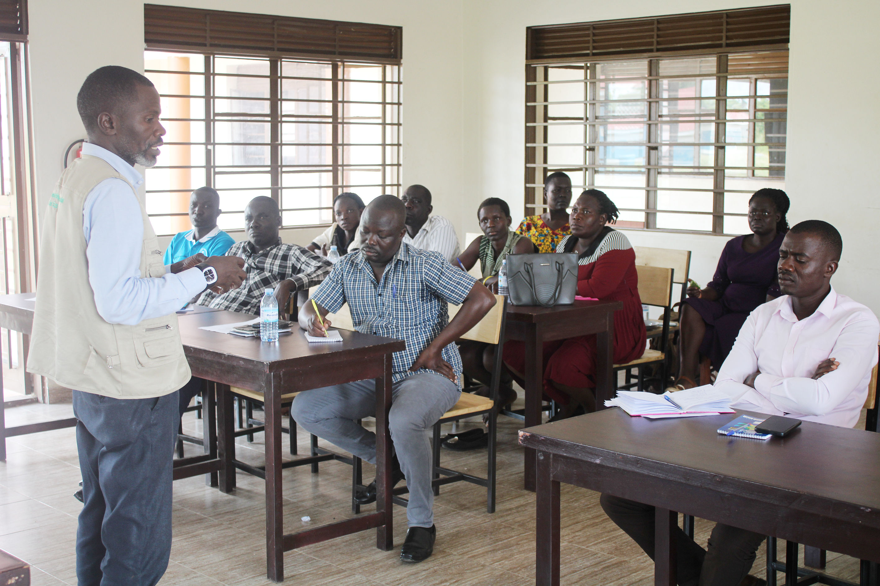 Gerald Kyalisima, the regional manager Village Enterprise explaining about the program to the participants in a meeting on Monday.