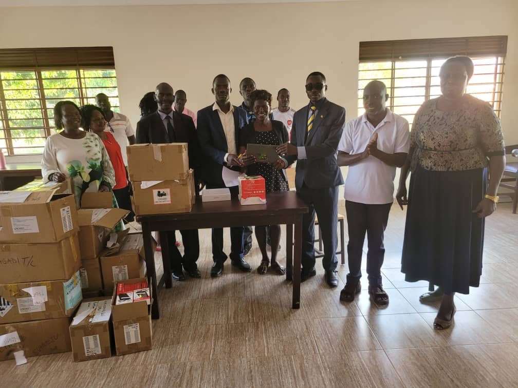 The Ass RDC, Esele Julius (on tie) officiating the distribution of tablets to selected staff last week. Photo by Emmanuel Opio