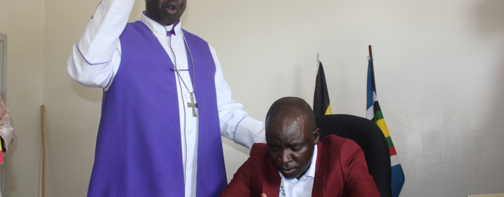 Francis Akorikin, the District Chairperson being blessed in his office by the Pentecostal ArchBishop of Uganda, recently