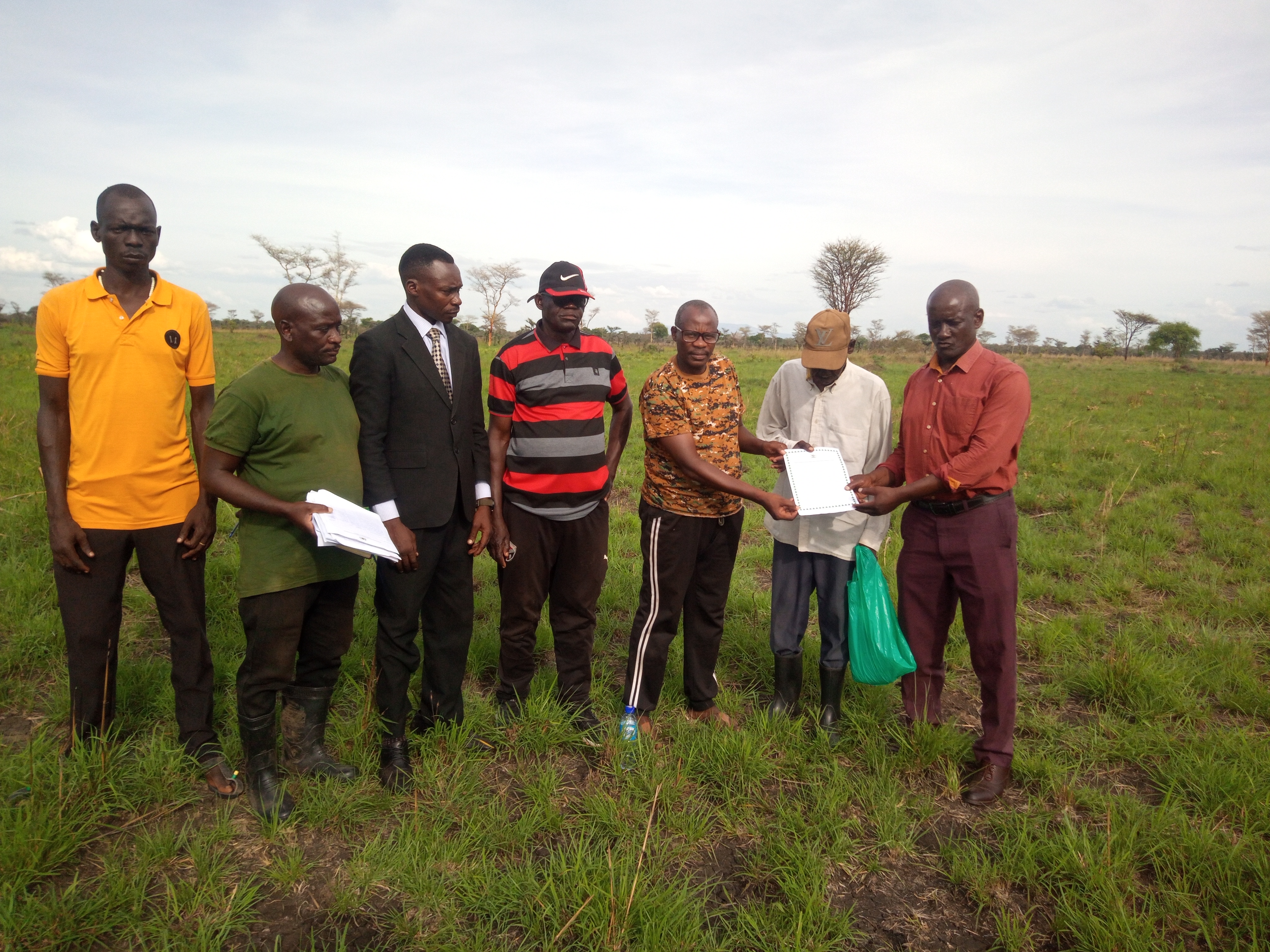  The Resident District Commissioner, Mr Olinga Tom Otukol with stakeholders of Aturai village displaying the site handover certificate on Thursday.